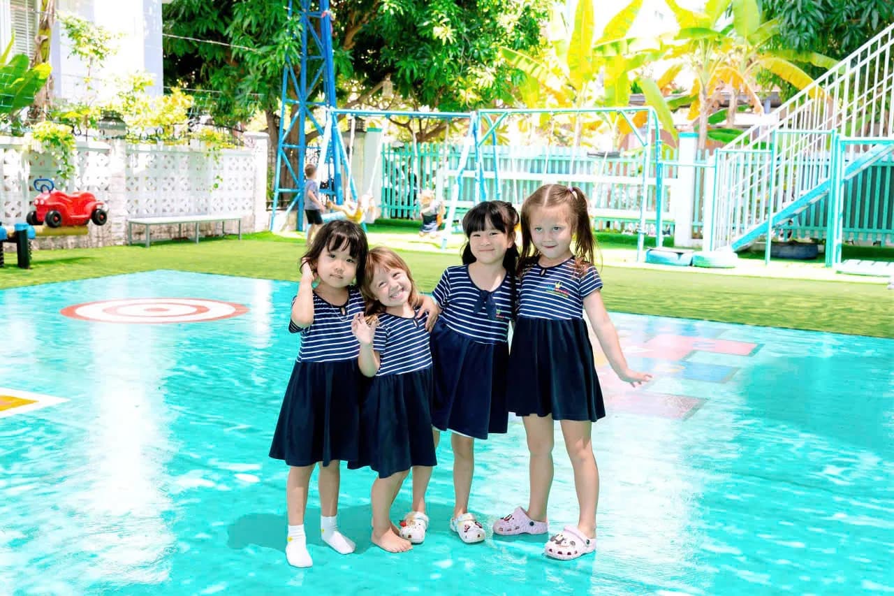 Kid Castle students smiling together on the playground